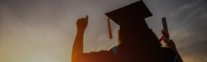 graduate celebrating facing the sunset