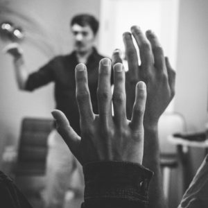 student raising hand in lecture