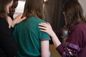 students comforting each other